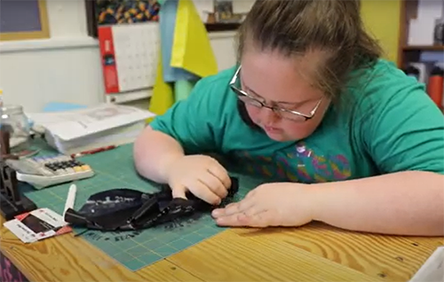 Faith working on a piece of clothing design